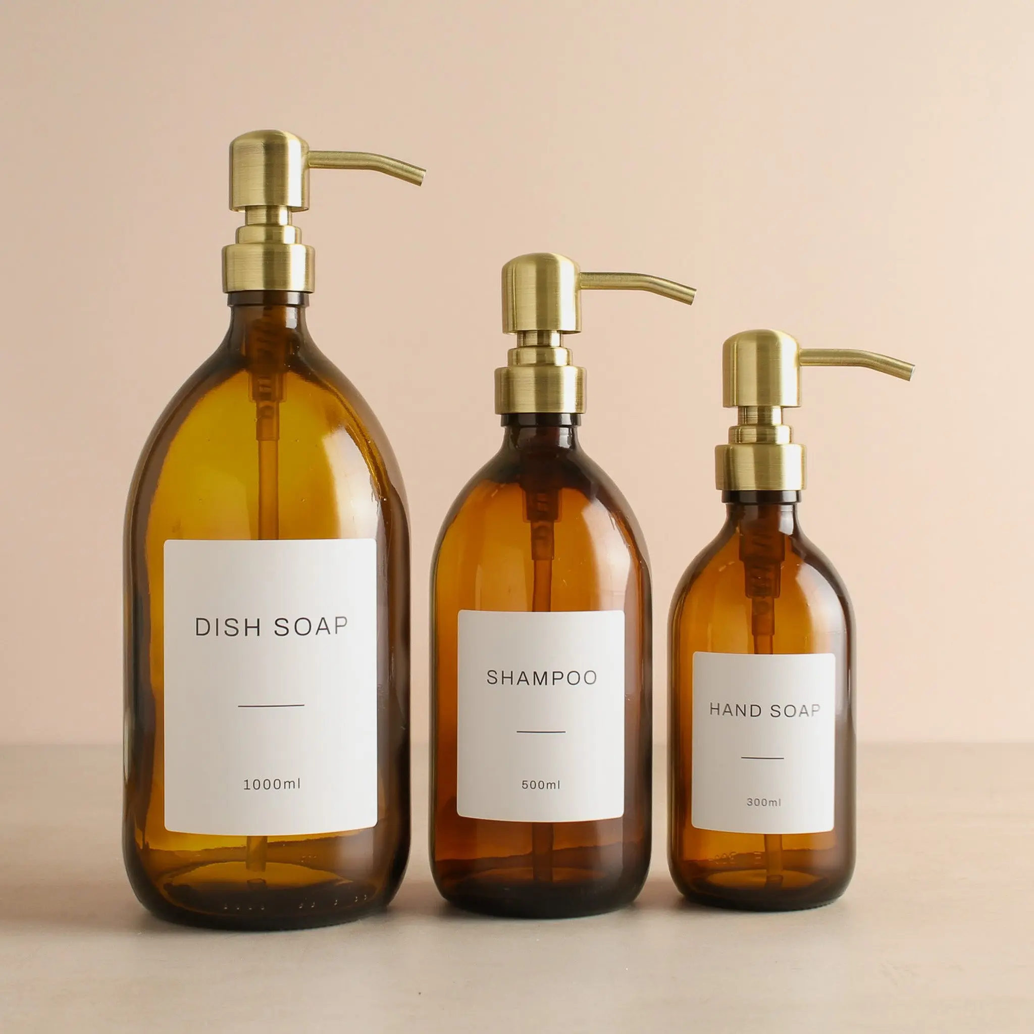 Labelled Amber Glass Dispenser Bottle With Gold Pump