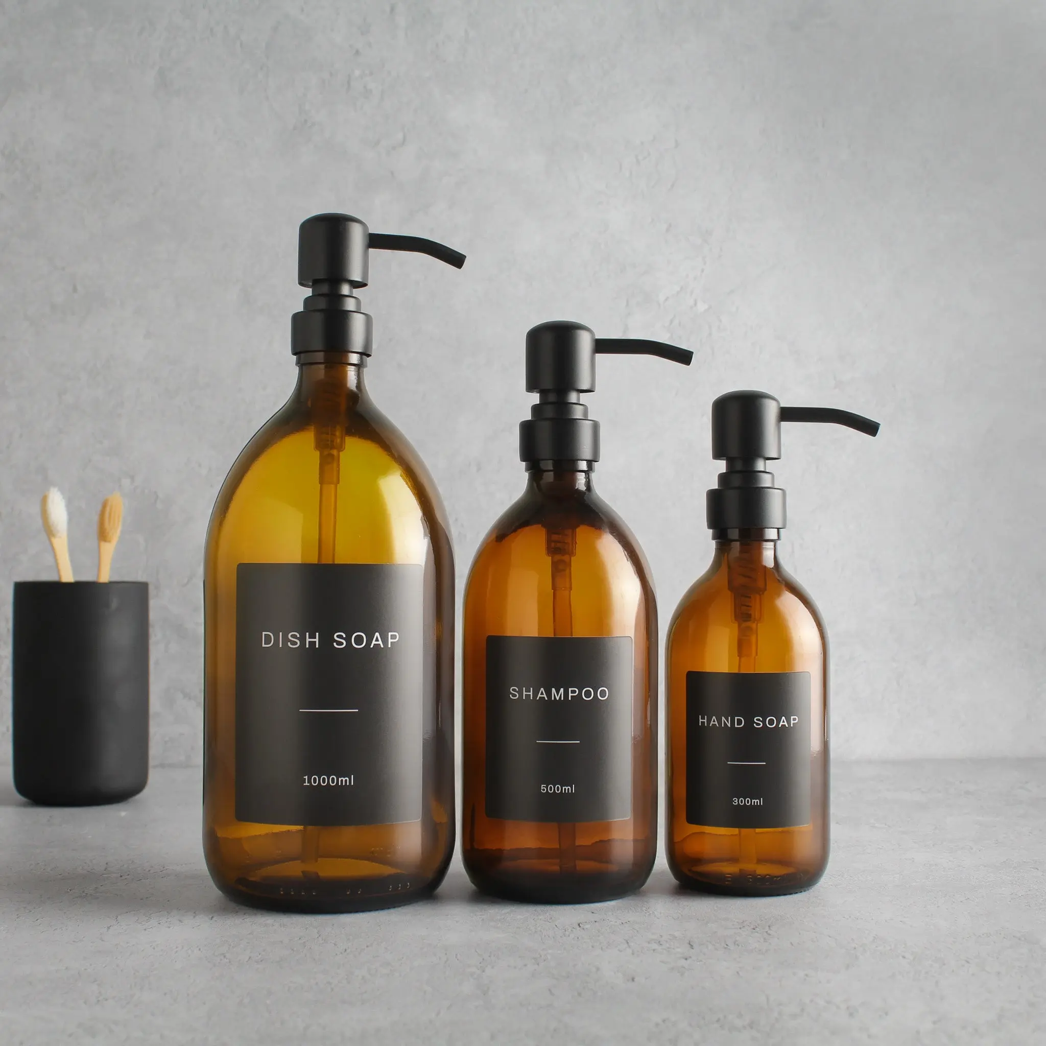 Labelled Amber Glass Dispenser Bottle With Matte Black Pump - Image 2