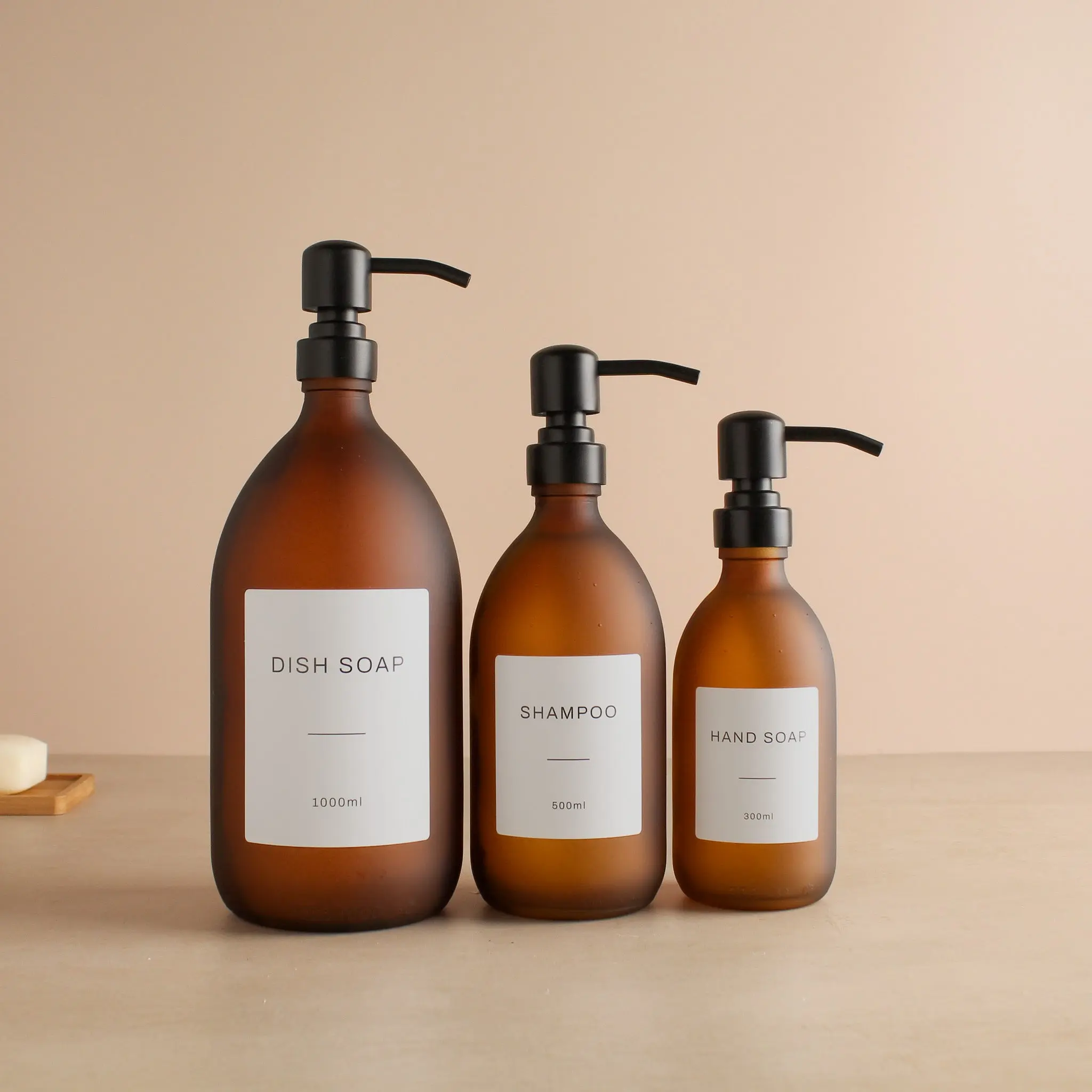 Labelled Frosted Amber Glass Dispenser Bottle With Matte Black Pump - Image 2