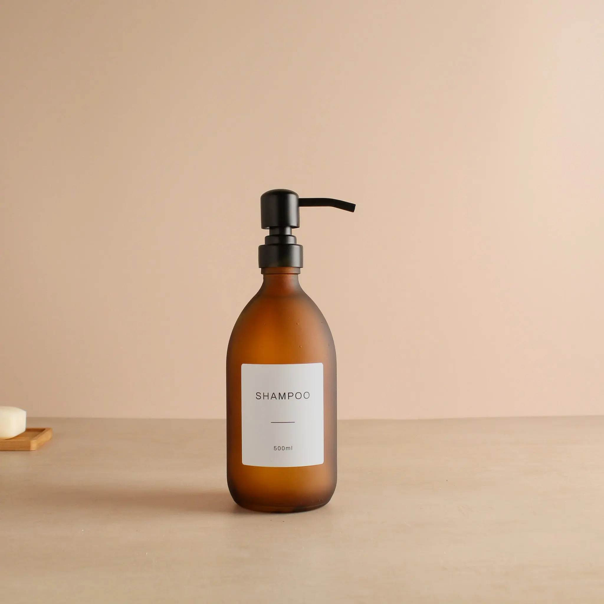 Labelled Frosted Amber Glass Dispenser Bottle With Matte Black Pump - Image 4