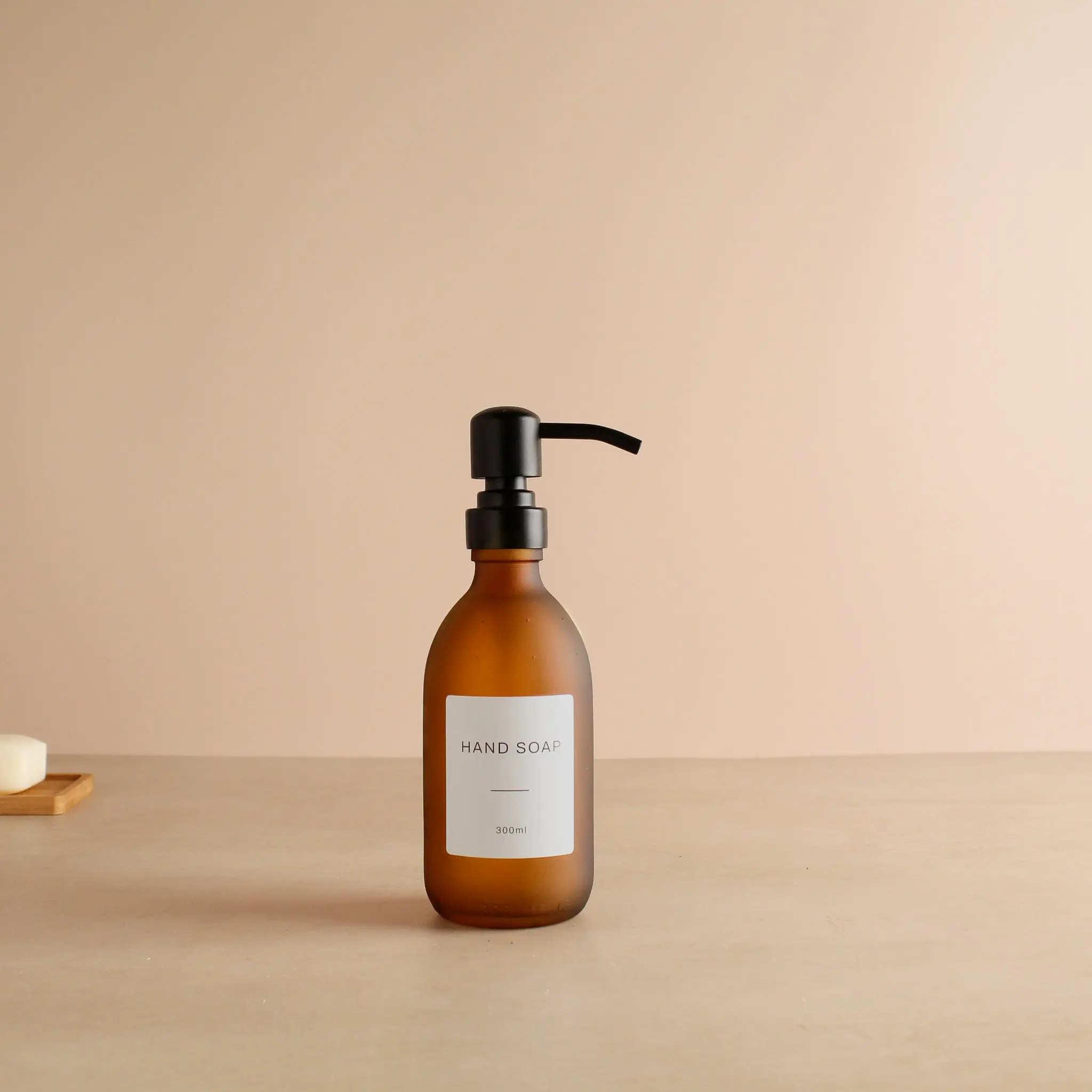 Labelled Frosted Amber Glass Dispenser Bottle With Matte Black Pump - Image 5
