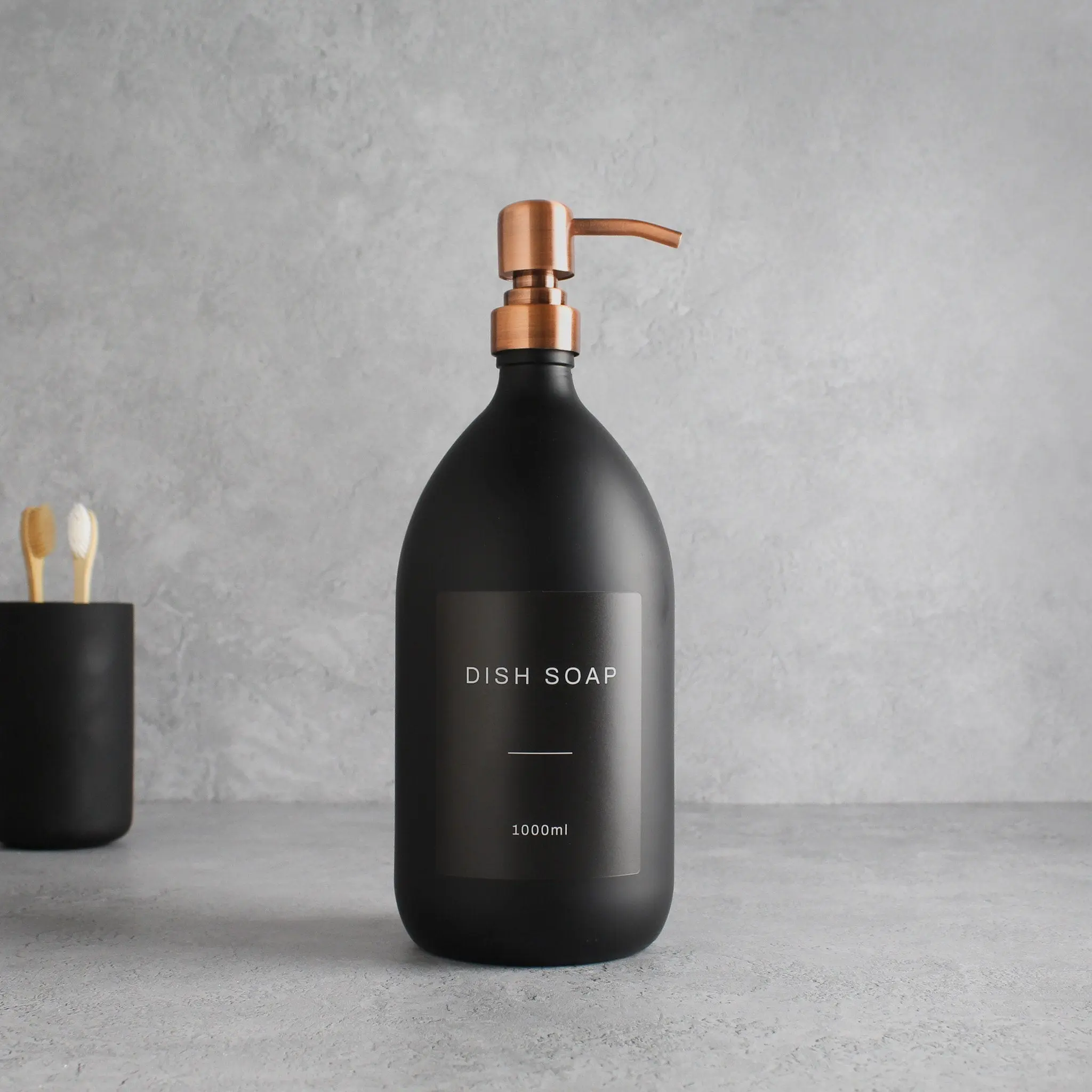 Labelled Matte Black Glass Dispenser Bottle With Rose Gold Pump - Image 3